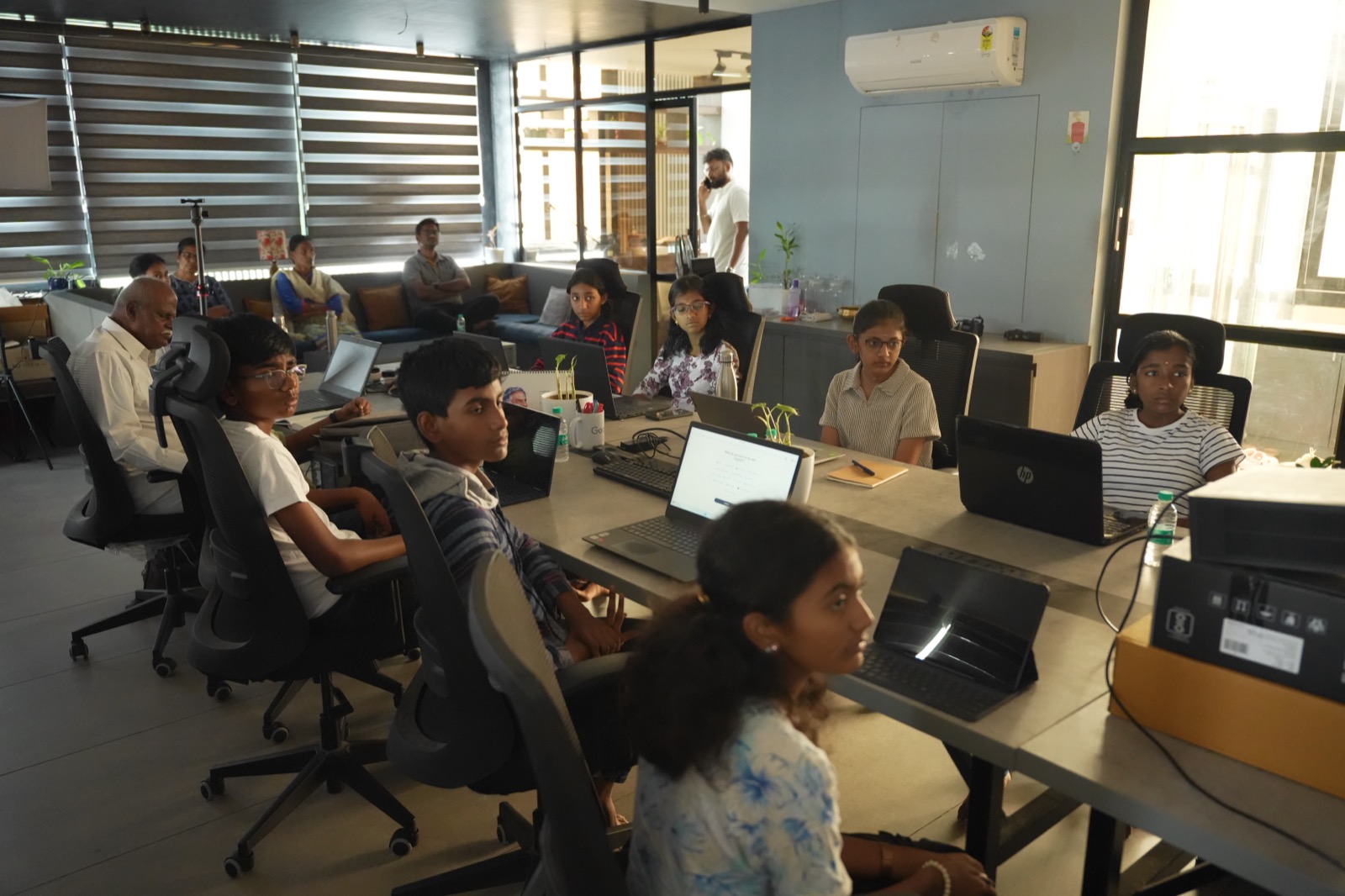 A full room of students during a Rewire AI session, with parents watching from the back
